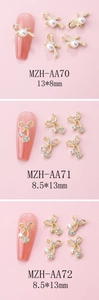 Detailed view of alloy bowknot nail charms with rhinestones and pearls on pink nails