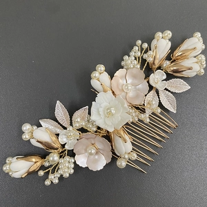 Elegant gold bridal hair comb with handmade ceramic flowers and white imitation pearls