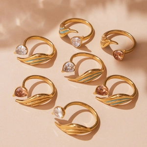 Golden teardrop zircon ring set with feather design and blue enamel accents