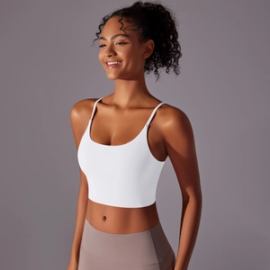 Close-up of white yoga tank top with thin straps and deep U-neckline detail