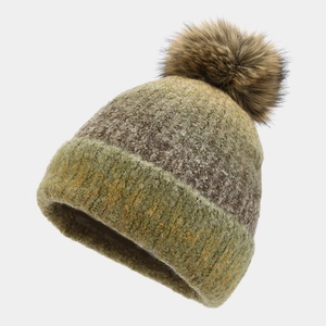 Detailed close-up of knit texture and brown faux fur pom-pom on tie-dye winter beanie