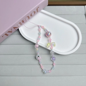 Detail of pink and blue tulip beaded phone strap with acrylic hearts and bows on a tray