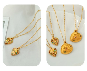 Detail of gold heart pendant with colorful crystals and organic textured charm necklace