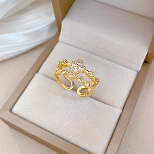 Adjustable gold clover ring with double-layered pavé cubic zirconia inlay in a luxury box