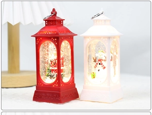 Close-up of lighted Santa and Snowman lanterns with internal glitter and festive scenery