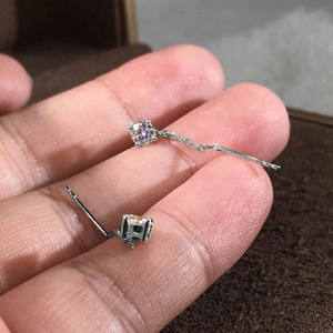 Dettaglio di eleganti orecchini a catenella in argento con zirconi a taglio tondo