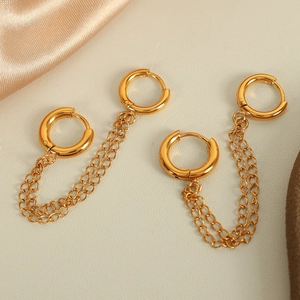 Elegant gold double circle earrings with twin chain connectors on a beige textured background