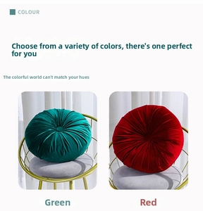 Detail view of round velvet pumpkin pillows in green and red with pleated fabric texture