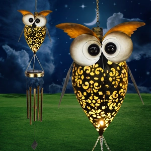 Detail of owl solar wind chime with metal tubes and cutout patterns for garden decor