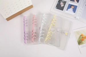 Close-up of A5 A6 6-ring PVC binder covers with purple, pink, white, and yellow clips