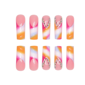 Long coffin gradient nails with pink base, glitter, and V-shaped rhinestone accents
