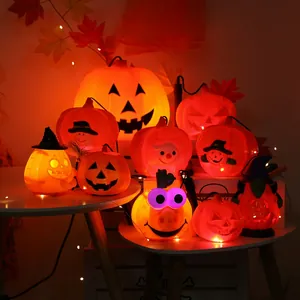 Various LED Halloween pumpkin lanterns with wizard hats on a cozy festive table