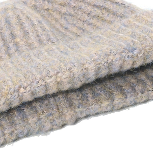 Close-up of thick ribbed knit fabric in light gray with blue and yellow fiber accents