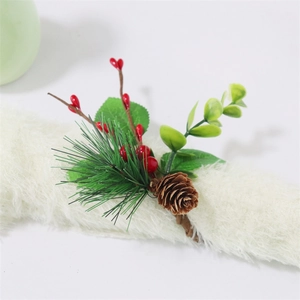 Christmas napkin ring featuring pine needles, red berries, and cones on a brown loop