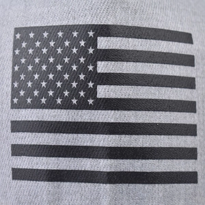Macro detail of US flag print on gray woven fabric of a hip hop flat brim hat
