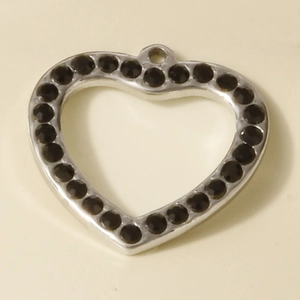 Detail of silver heart pendant with black rhinestones and circular hanging ring