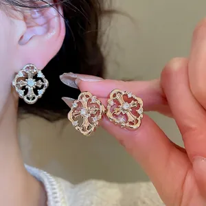 Elegant gold hollow cross stud earrings with sparkling white zircons for daily wear