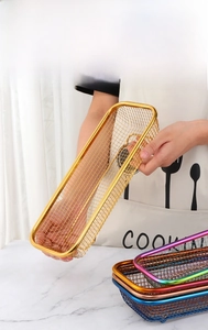 Detail of stainless steel cutlery basket with smooth rounded edges in golden finish