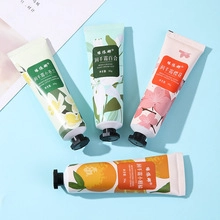 Flat lay view of four scented 30g hand cream tubes including Jasmine and Sakura fragrances