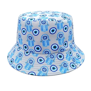 Close-up of Evil Eye and Hamsa Hand patterns on this gray foldable cotton bucket hat