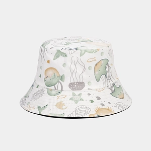 Close-up of white bucket hat with colorful watercolor marine life and cartoon fish patterns