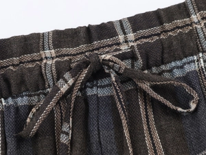 Makroansicht der elastischen Taille mit Kordelzug an braun-grauer Karo-Stoffhose