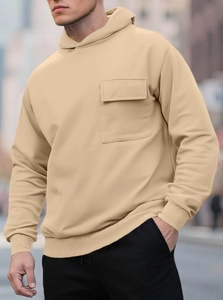 Detail view of khaki fleece hoodie featuring a functional chest pocket and ribbed cuffs