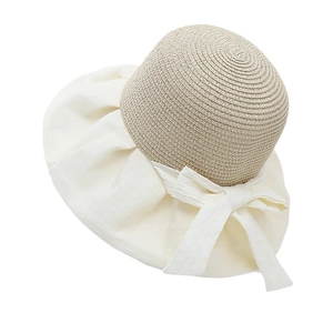 Women's hollow knit sun hat with bow tie and wide brim for UV protection in beige