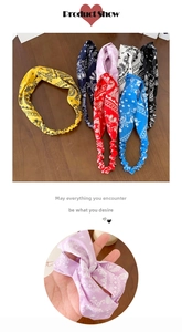 Detail of bohemian paisley print elastic headbands in various colors with twisted knot