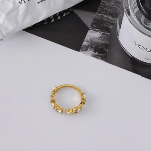 Close-up of adjustable gold ring with sparkling droplet and marquise-cut white zircons