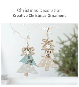 Detail of wooden Christmas tree ornaments with Let It Snow and Joyeux Noel lettering
