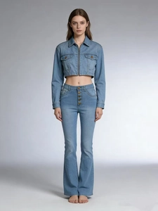Close-up of high-waist flared jeans with multi-button closure and raw hem details