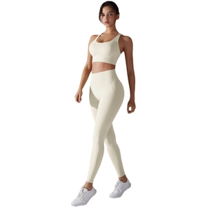 Two-piece beige yoga set featuring a high-waisted seamless legging and a racerback sports bra