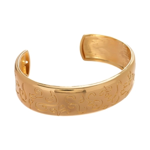 Golden oval open cuff bracelet with vintage floral relief pattern and brushed metal finish