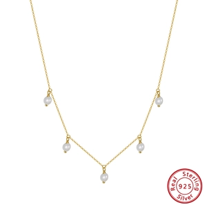 Close-up of five round freshwater pearls on a 925 sterling silver gold plated chain