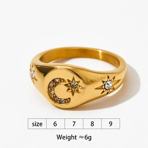 Macro detail of gold moon and star ring with sparkling white zircon stones