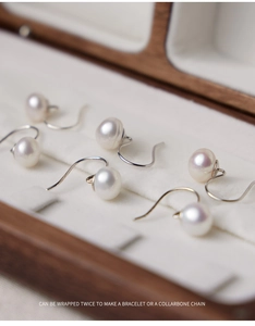 Macro detail of elegant 8-9mm white freshwater pearl earrings with s925 silver hooks
