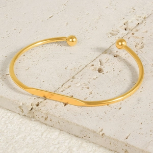 Minimalist 18k gold plated stainless steel open cuff bracelet on stone background