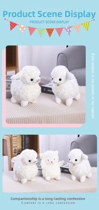 Detail of soft white sheep plush toy with curly wool texture and golden bell collar