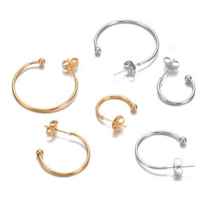 Detailed flat lay of C-shaped stainless steel hoop earrings in gold and silver finish