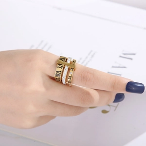 Macro detail of gold-plated triple layer Roman numeral ring with sparkling zircon stones