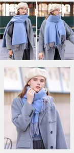 Detailed view of the soft blue pashmina scarf with stylish fringe edges on a model