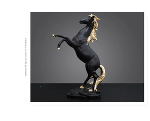 Detail of matte black and gold galloping horse statue on rock texture base