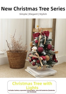 Close-up of a 45cm flocked mini Christmas tree with red bows and warm LED cabin lights