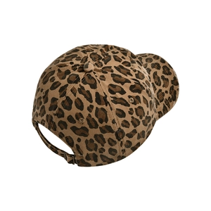 Detail of adjustable metal buckle and leopard print texture on a distressed baseball cap