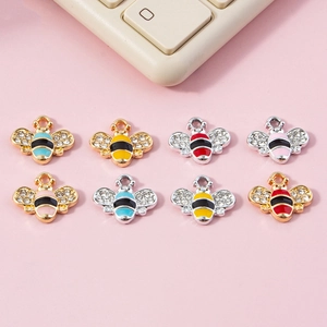 Golden and silver enamel bee pendants with sparkling rhinestones in various colors