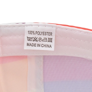 Detail shot of internal wash label on rainbow striped cap showing 100% polyester material