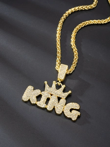Close-up of gold iced-out KING pendant on a twist chain with high-quality diamonds