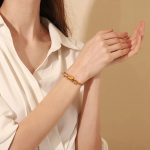 Detail of 18K gold-plated double-layer chain bracelet with coin pendant and beads