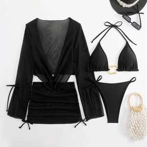 Flat lay of black 4-piece bikini set with sheer mesh cover-up and golden heart buckle